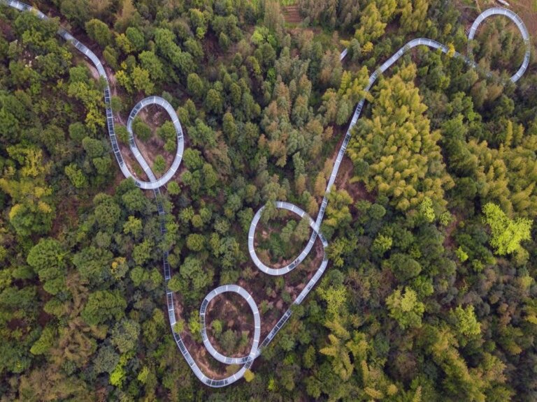 Glass water slide layout options on a hillside
