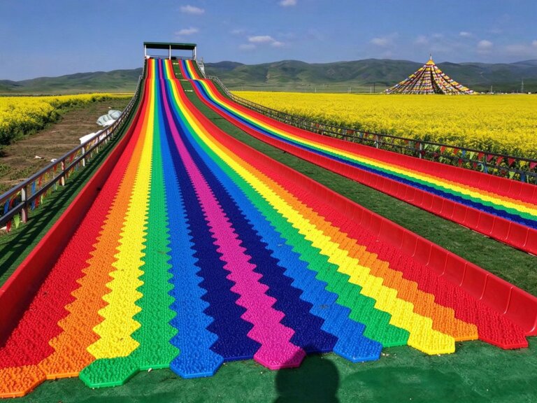 Multi-lane rainbow dry slide on a grass slope