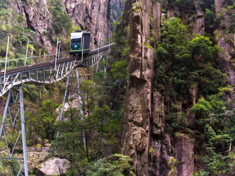 Funicular car and conveyor lift carrying guests up a slope